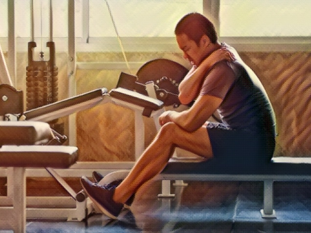asian Muscular man suffering from shoulder injury while exercising at gym in morning light