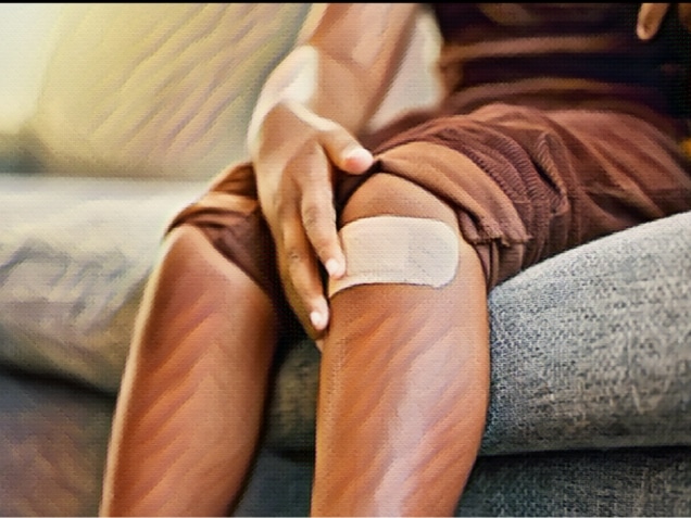 Child with plaster or bandaid, injured and hurt by accident while playing a sport, exercise or outside