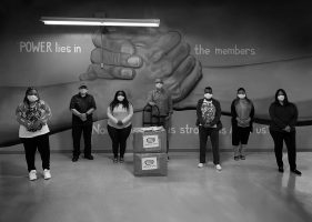 Ankin Law employees poses with essential workers with the donated masks and sanitizers