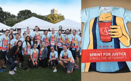 Race participants posing while wearing the winning Race Judicata tshirt design