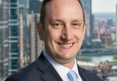 Ankin Law Workers' Compensation attorney Josh Rudolfi closeup in a business suit.