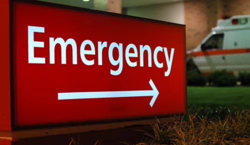 Ambulance sitting behind ER sign
