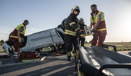 Paramedics with a patient in a stretcher.