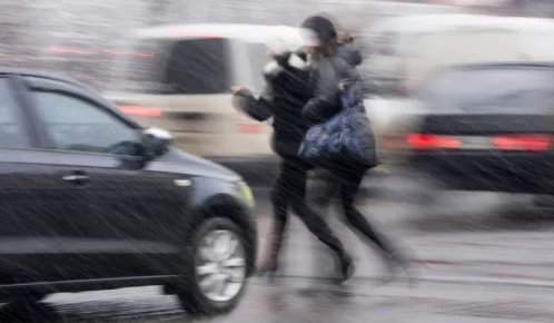 Pedestrians rushing to cross the street.