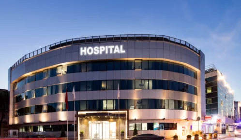 Hospital with cars on the street.
