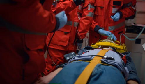 Paramedics aiding an injured man.