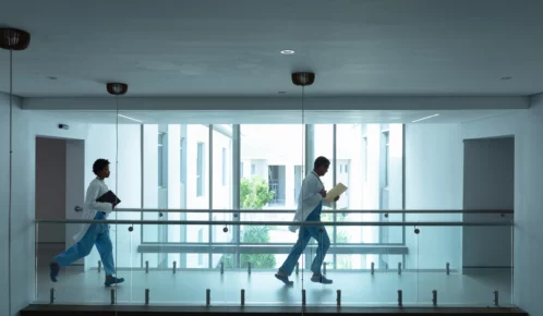 Two hospital staff rushing to the emergency room.