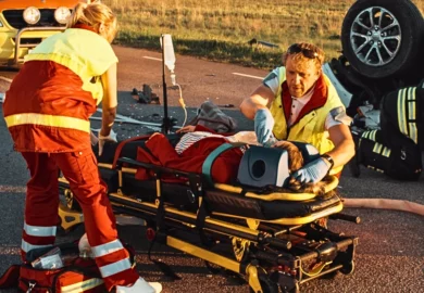 On the Car Crash Traffic Accident Scene: Paramedics Saving Life of a Female Victim.