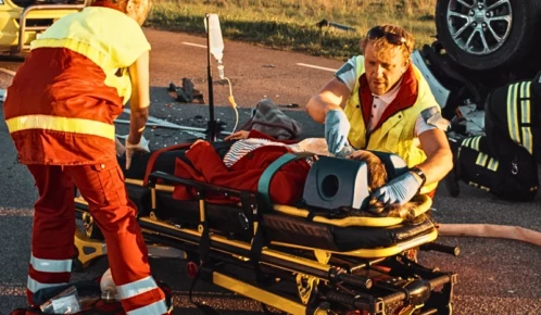 On the Car Crash Traffic Accident Scene: Paramedics Saving Life of a Female Victim.