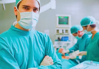 Surgeons inside an operating room with a patient on the table. marginal cord insertion