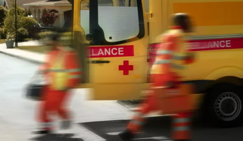 Paramedics rushing to rescue injured people from an accident.