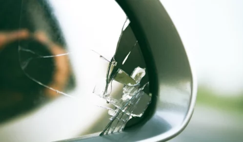 Broken side mirror of a car due to an accident.