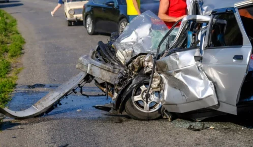 Wrecked gray sedan car after a horrific car crash.