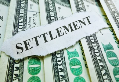 Settlement newspaper headline on money. Paragard IUD Lawsuit Settlement Amounts​