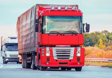 Arriving white truck on the road in a rural landscape at sunset. Trucking Companies Put Profit Over Safety