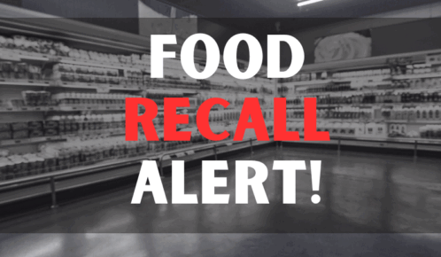 Defocused blur buying milk put on shelf in supermarket with food recall texts.