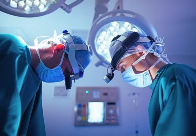 Surgeons wearing surgical loupes while performing operation in operation theater.