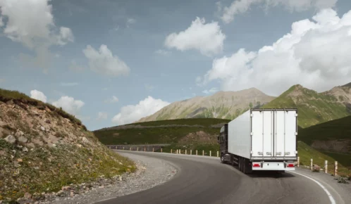 semi truck driving on a curve lane.