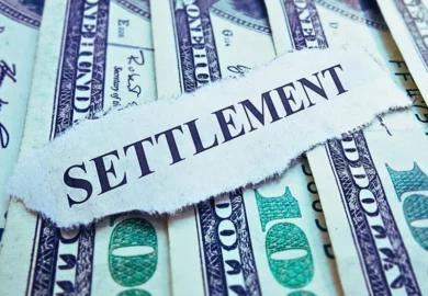 Settlement newspaper headline on money.