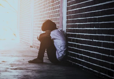 Sad boy hiding at school after abuse.