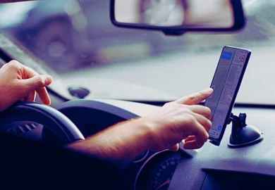 Driver man using mobile phone navigator app. Car Accidents Caused by GPS