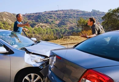Two men arguing about damaged cars. Rear-End Collisions Can Be More Legally Complicated