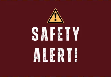 Safety alert sign with warning triangle and bold distressed text on a red background.