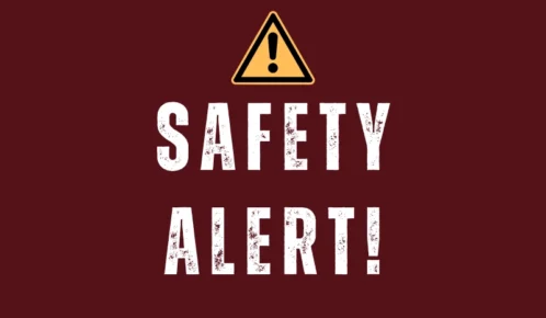 Safety alert sign with warning triangle and bold distressed text on a red background.