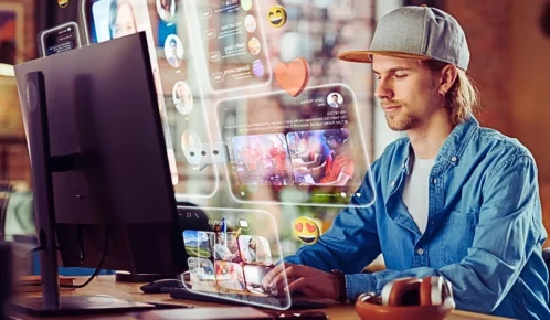 Young Handsome Man Using Desktop Computer To Check Social Media.