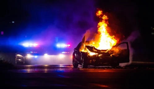 Car on fire in the night.