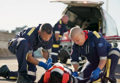 Patient being carried in the ambulance.