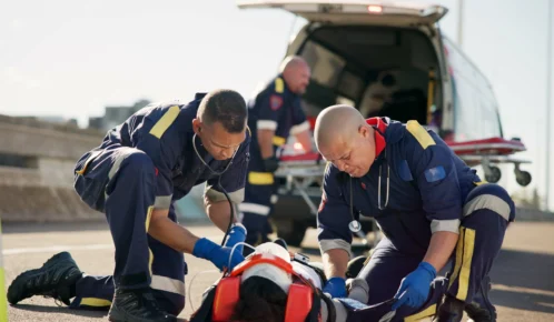 Patient being carried in the ambulance.