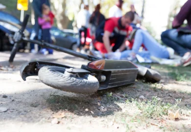 Injured woman riding her scooter got hit by a car.