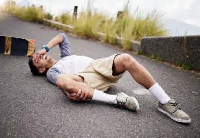 Injured man using skateboard.