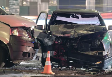 T-bone accident between a white and a black car.