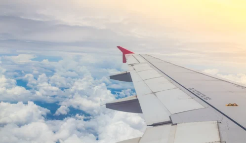 Airplane wing on a sunset view.