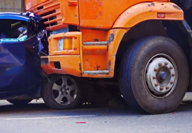 Orange truck struck a blue sedan car.