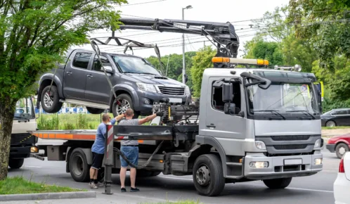 Car being lifted by a tow truck.