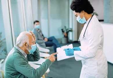Doctor and patient in masks reviewing a clipboard. Hospital Policies vs Patient Safety