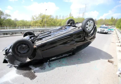 Rollover crash and a police car.