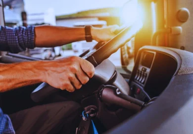 A truck driver holding the steering wheel. Truck Drivers Injured in Truck Accidents