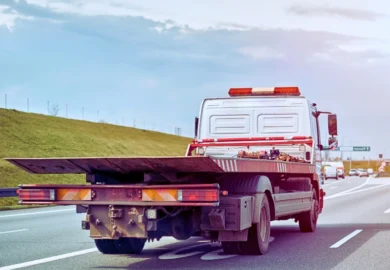 A tow truck in the middle of road. When Debris Falls From a Truck