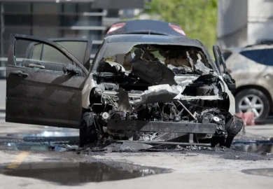 Burnt sedan car after an accident.
