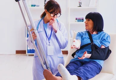 Female doctor holding crutches talking to an injured patient. Bad Medical Outcome Was Malpractice