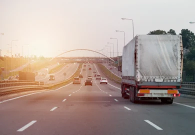 Truck in the middle of am expressway.