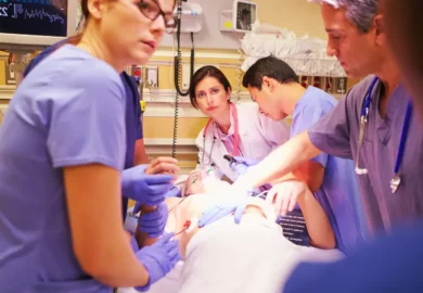 Healthcare worker comforting her exhausted colleague on hospital floor. inadequate staff training