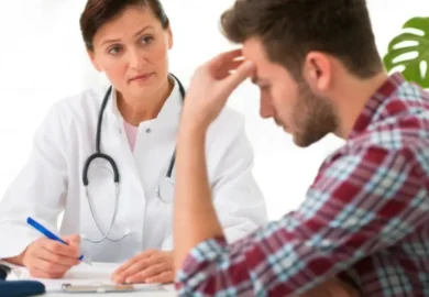 Female doctor listening attentively to stressed male patient. missed test results