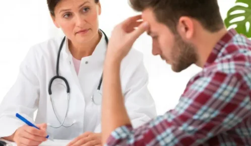 Female doctor listening attentively to stressed male patient. missed test results