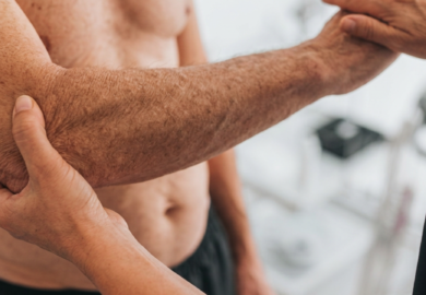 Doctor examinating a wrist and arm injury on a man
