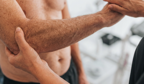 Doctor examinating a wrist and arm injury on a man